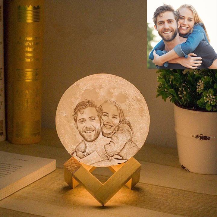 Personalized moon lamp with engraved couple portrait on a wooden stand, perfect for unique home decor and thoughtful gifts.