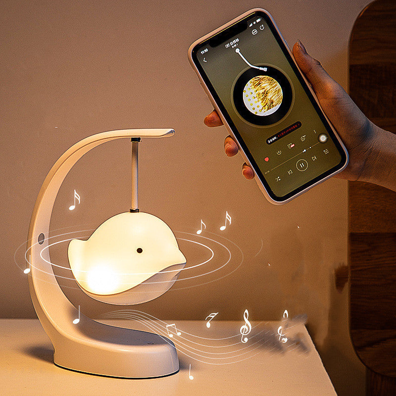 Innovative bird-shaped lamp with music notes and smartphone, perfect for modern table or desk ambiance.