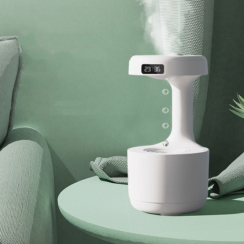 Modern white humidifier on a green table enhances home decor with soothing mist and digital time display.