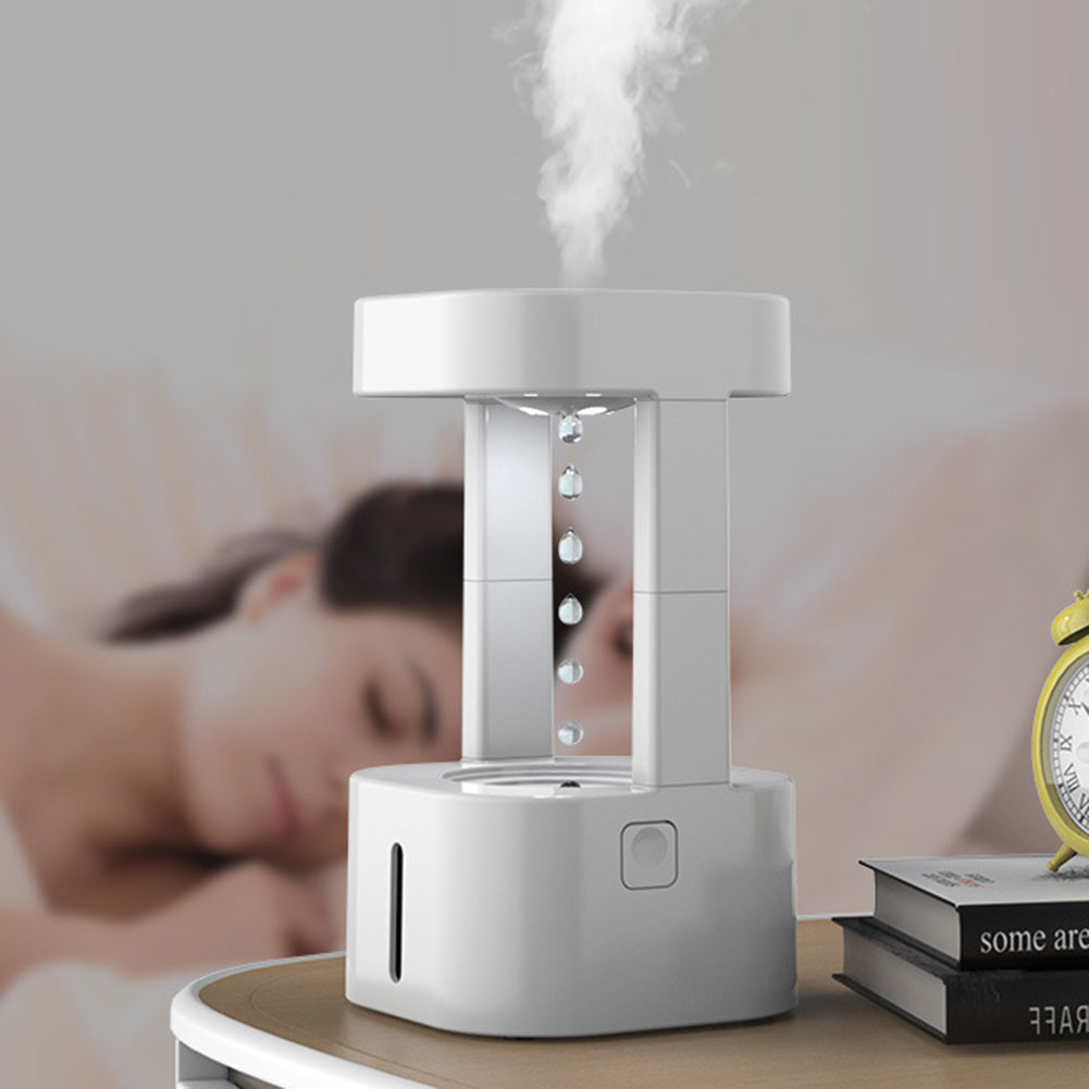 Anti-gravity water drop humidifier on a bedside table in a quiet bedroom setting.