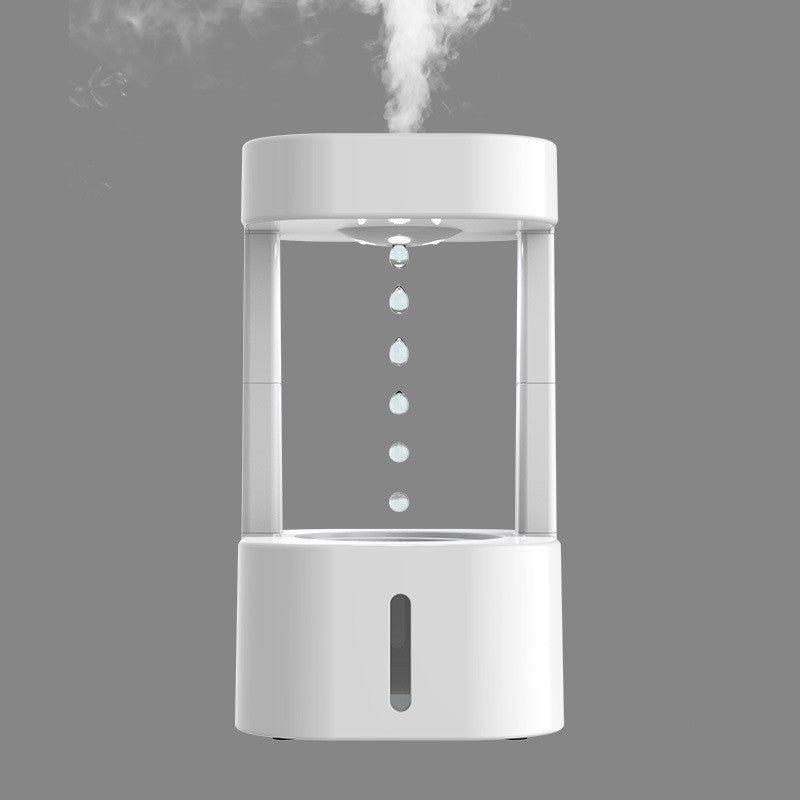 Anti-gravity water drop humidifier with mist spray on gray background.